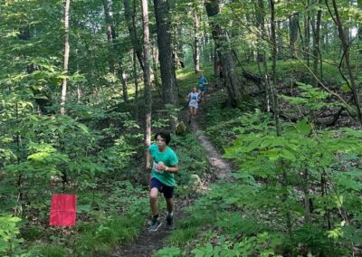 Runners on a trail through the woods during the Ice to Water Race.