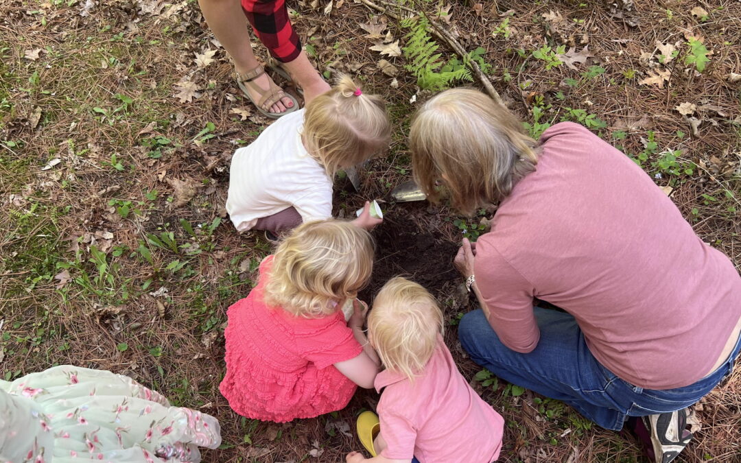 Nature Storytime kids look for worms in the soil.